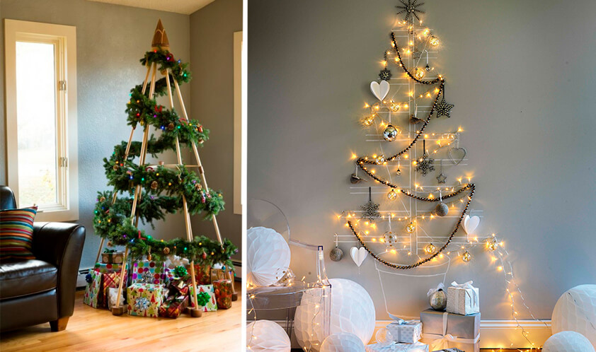 duas arvores de natal, uma feita na parede com pisca pisca e outros enfeites natalinos e outra feita com madeira e enfeites.