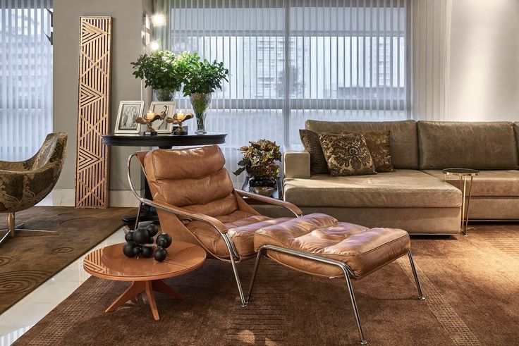 sala grande com sofa grande e poltrona estilo barcelano nas cores bege e morrom.