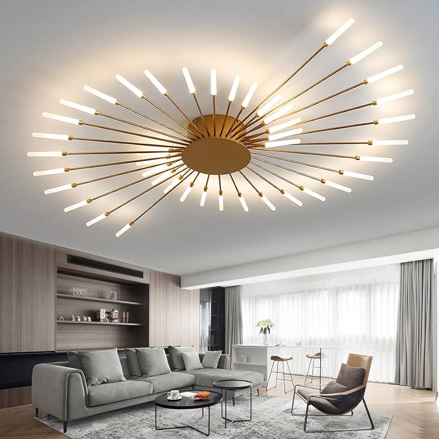 sala de estar ampla e moderna, com sofá grande em L na cor cinza com almofadas na mesma cor e tecido do sofá, duas mesinhas de centro redondas, cadeira com almofadas, ao lado do sofá uma janela grande com cortinas grandes nas cores branco e cinza.. em cima no teto uma luminária de teto bem moderna.